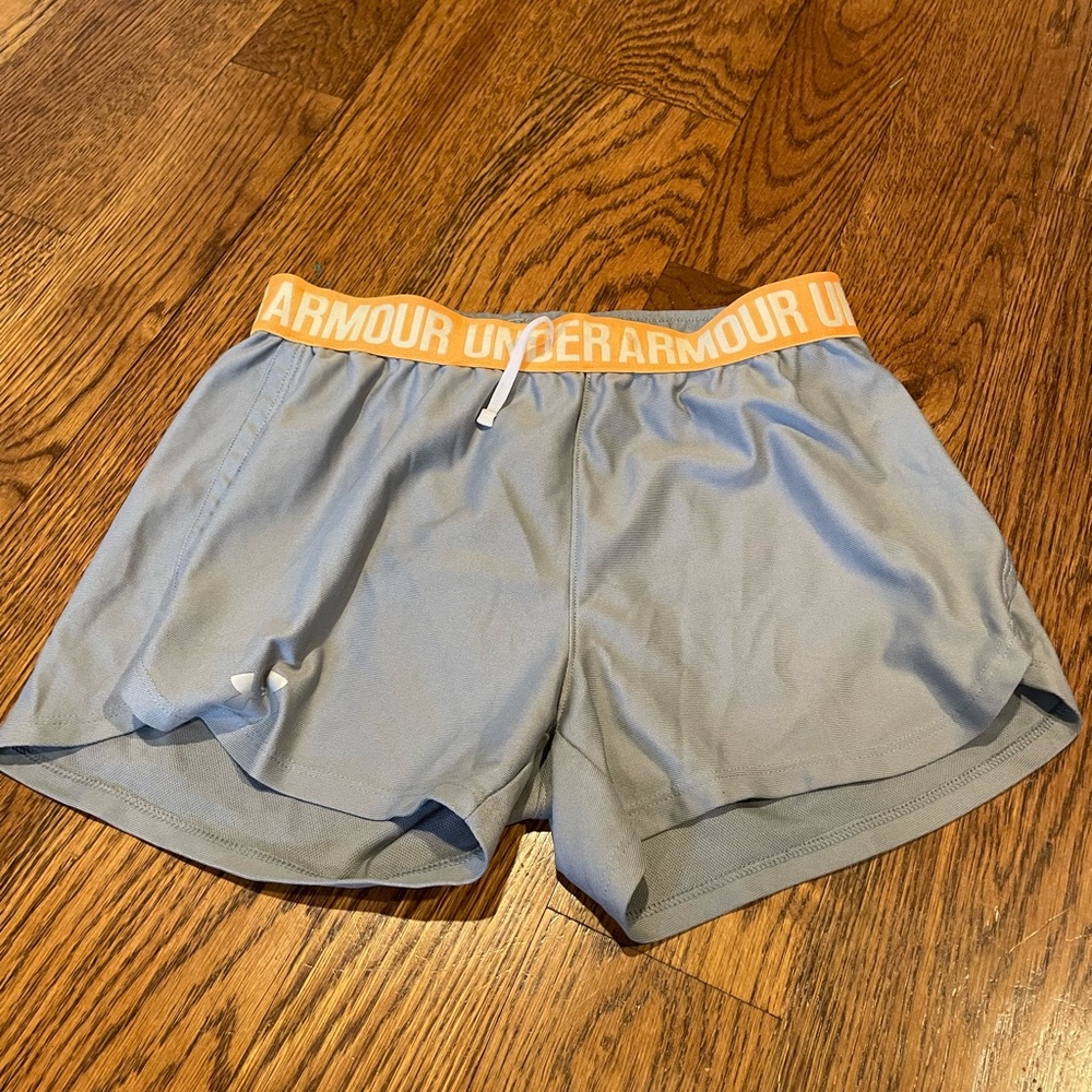 gray under armour shorts with a orange adjustable waistband